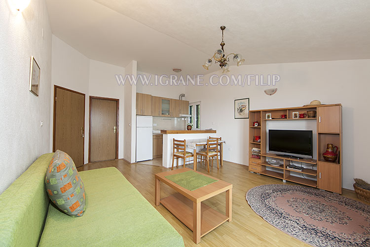 living room with sofa, dining table, LCD TV